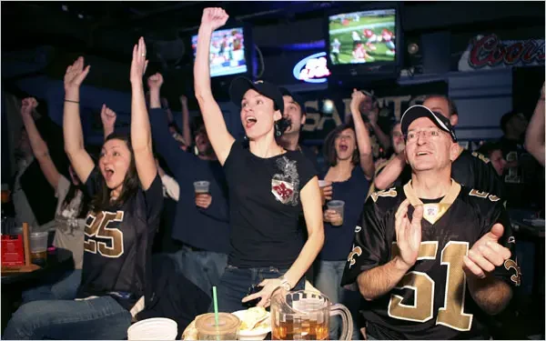 Saints fans celebrating in jerseys